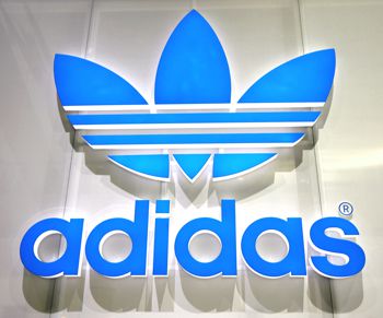 A finished addidas sign with vinyl applied to the letters 