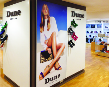 Inside a shoe shop showing large format prints on digifilm media on the wall.