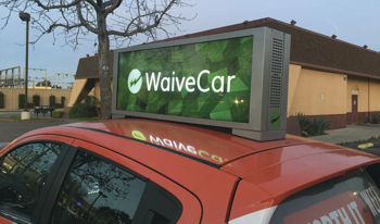 sign on top of a car that says waive car