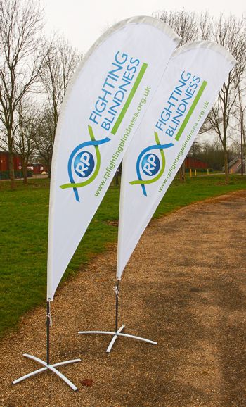 Promotional teardrop flags standing on a pathway