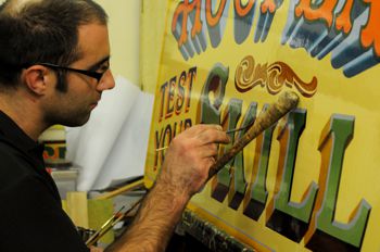 Signwriting by hand for an attraction at Carters Steam Fair