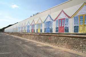 Garage that houses the land train on Boscombe seafront decorated using designs produced by eight year olds.