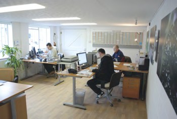 The office with staff at their desks.