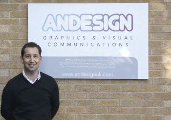 Andy Williams in front of the Andesign company sign.