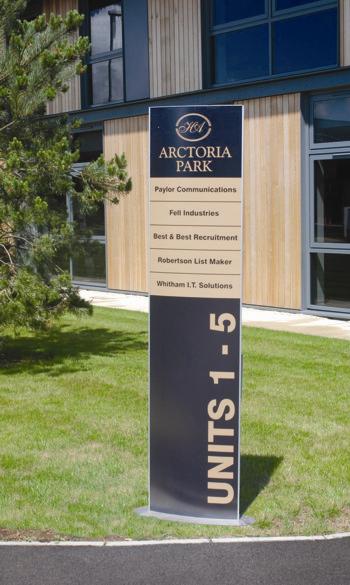 Totem monolith sign incorporating part directory, with vinyl graphics for exterior use.
