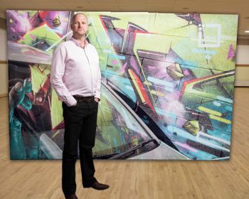 Paul Tomlinson in front of a fabric display