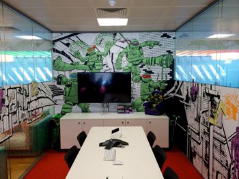 Walls of an office covered in cartoon style wall covering