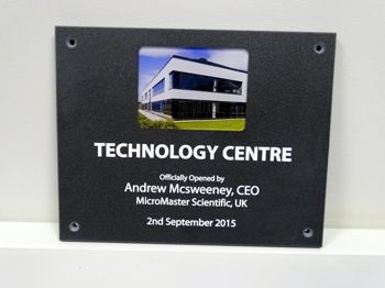 A plaque with a photo printed on it