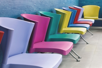 Row of coloured chairs made from CRYLUX CAST