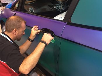 man wrapping a car with vinyl