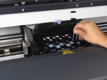 Inside a large format inkjet printer showing the ink cartridges