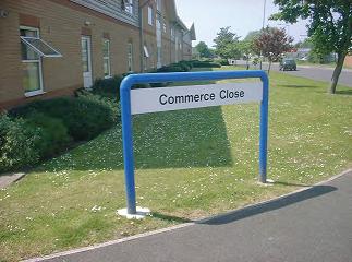 Street sign by Western Signs saying Commerce close