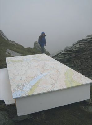 The digitally printed map and frame on a rock in the mountains