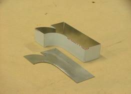 Letter with Stainless Steel folded strip next to it.