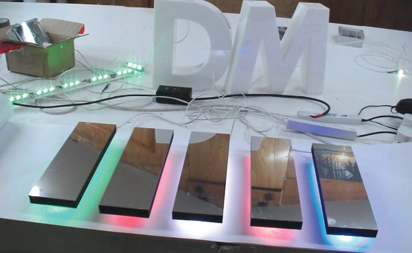 Mirror finish composite laminated letters with plug together LEDs shown in several colours.
