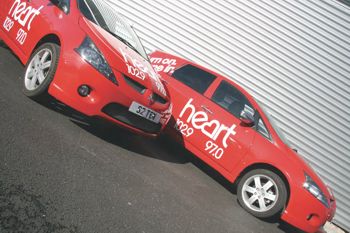 Vinyl wrapped cars showing the FM brand