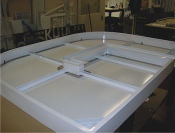 Painted, polycarbonate back trays with block out vinyl applied.