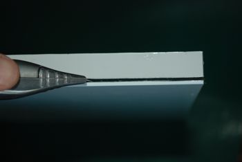 Aluminium Composite being cut with a blade.