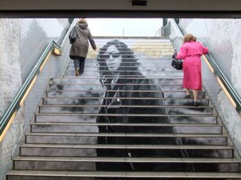 ASLAN floor graphic of a person applied to concrete stairs