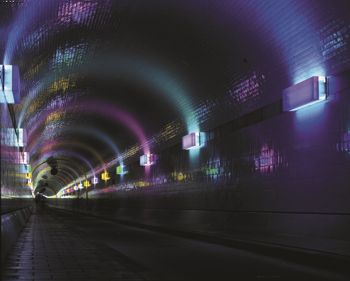 A tunnel lit with coloured glass film