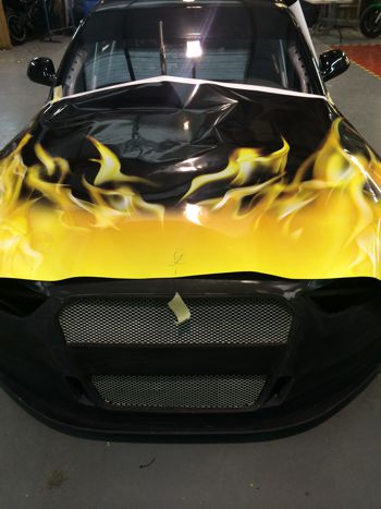 Front of a car being wrapped in vinyl