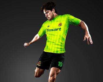A footballer wearing neon yellow shirt