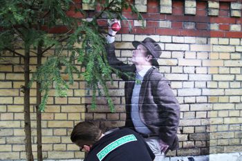 person applying decorated film to brick wall