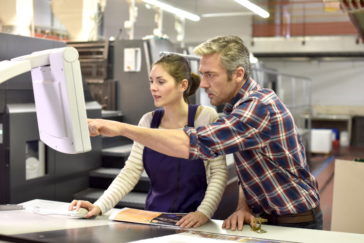 Man giving instructions on how to print to a colleague