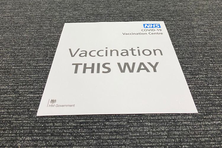 Vaccination this way sign printed onto a vinyl and applied as a floor graphic to carpet