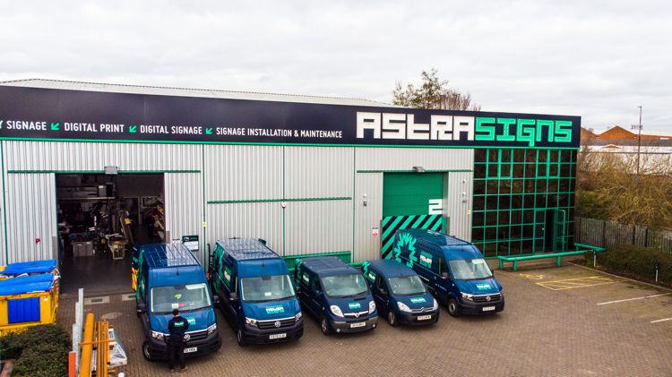 Aerial photo of the outside of Astra Signs premises with 5 of their vans outside.