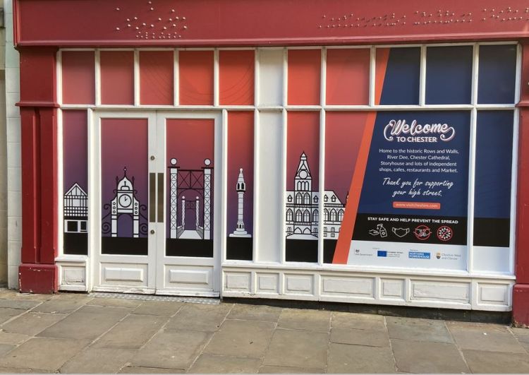 A vacant shop front decorated with Vinyl graphics in Chester