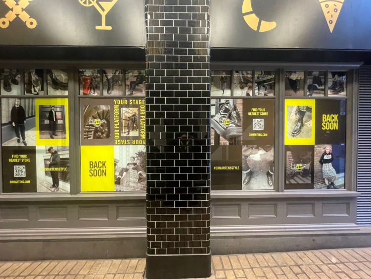 The front of the Dr. Martens store covered in printed graphics to cover up work during its refurbishment.