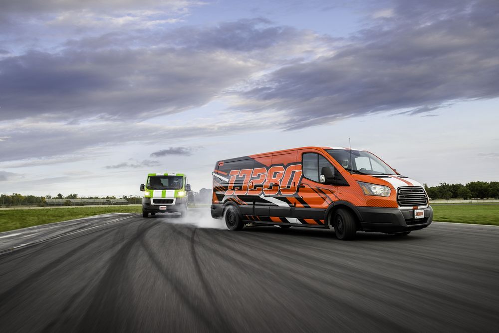 Vans wrapped with the IJ280 film with tyres smoking while racing on a race track
