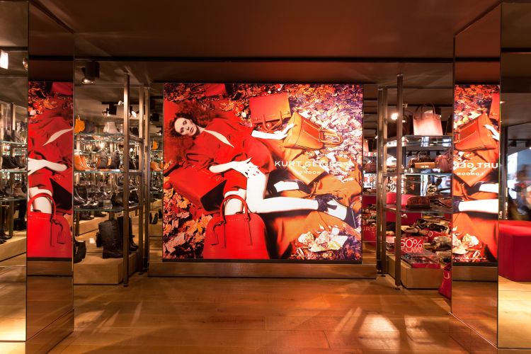 A Kurt Geiger shop interior with colourful printed graphics.