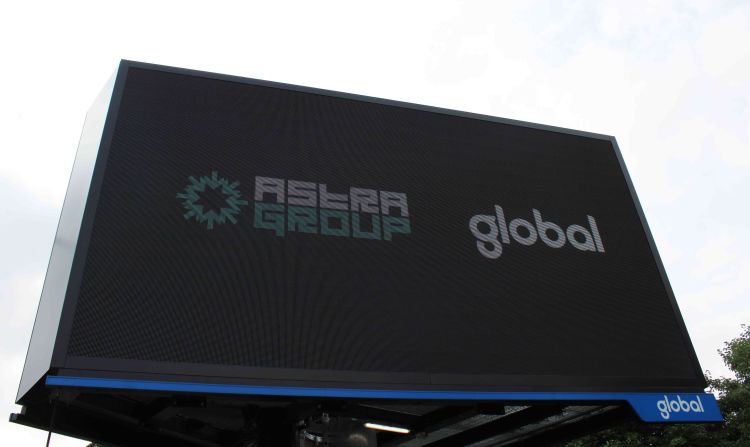 Electronic sign showing Astra Group and Global logos