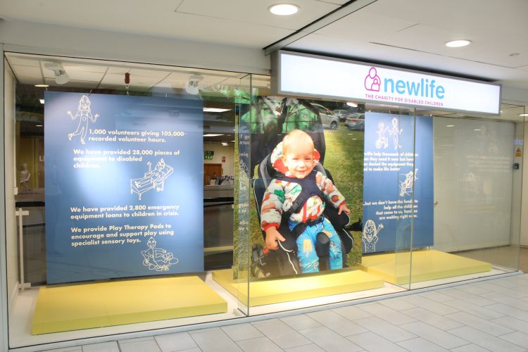 store signage with baby in harness