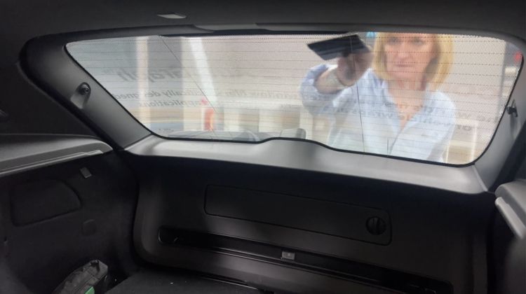 Contra Vision Autograph being installed on a rear car window. Image is looking from the inside of the car outwards.