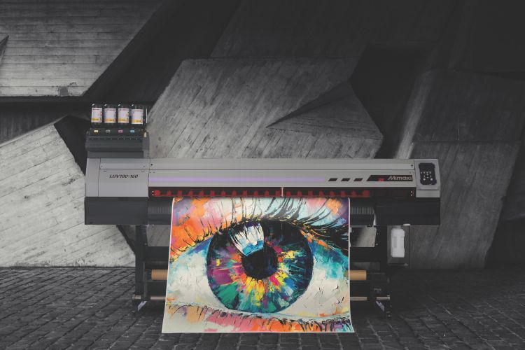 A Mimaki roller printer is printing a high quality, multi-coloured eye onto vinyl 